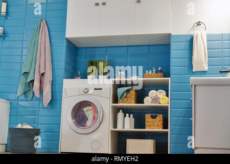 modern bathroom with white washing machine and blue tile Stock Photo