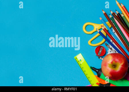 Back to school background with accessories for the schoolroom - paints, pencils, notebooks, books, scissors, chalk, markers, blue background, above co Stock Photo