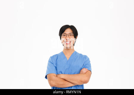Confident asian man doctor wearing uniform standing isolated over white background Stock Photo