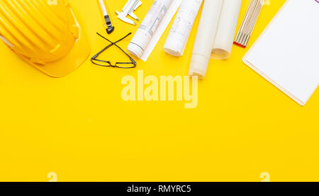 rolls of blueprints with wooden ruler and safety helmet Stock Photo - Alamy