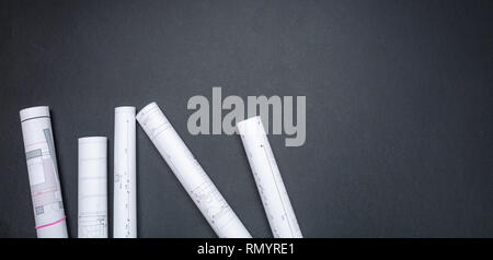 Construction project concept. Architecture Blueprint rolls on black color background, copy space, top view Stock Photo