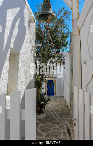 alley with a bell on the cycladic island of Paros, Greece Stock Photo