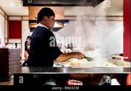 Riviera Maya, Mexico - July 28, 2018. Japaneses Tepanyaki chef prepares food in a luxury restaurant with an exciting show as steam rises from the stov Stock Photo