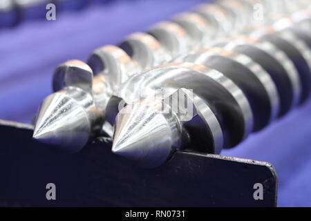 Screw press parts for plastic injection machine ; selective focus Stock Photo
