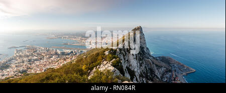 Panoramic view of top of Gibraltar Rock (United Kingdom), in Upper Rock Natural Reserve: on the left town and bay, La Linea town in Spain at the far e Stock Photo