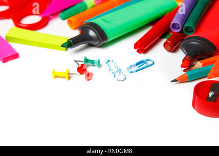 Assorted school supplies, including pens, pencils, scissors, glue and a ruler, on a white background Stock Photo