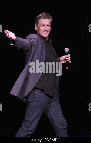 Craig Ferguson, television host, stand-up comedian, writer, actor, director, author, producer and voice artist, is shown performing on stage during a 'live' concert appearance. Stock Photo