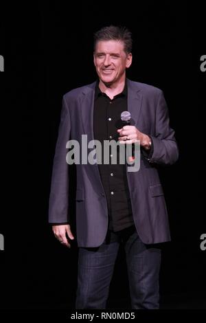 Craig Ferguson, television host, stand-up comedian, writer, actor, director, author, producer and voice artist, is shown performing on stage during a 'live' concert appearance. Stock Photo