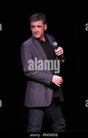 Craig Ferguson, television host, stand-up comedian, writer, actor, director, author, producer and voice artist, is shown performing on stage during a 'live' concert appearance. Stock Photo