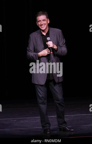 Craig Ferguson, television host, stand-up comedian, writer, actor, director, author, producer and voice artist, is shown performing on stage during a 'live' concert appearance. Stock Photo