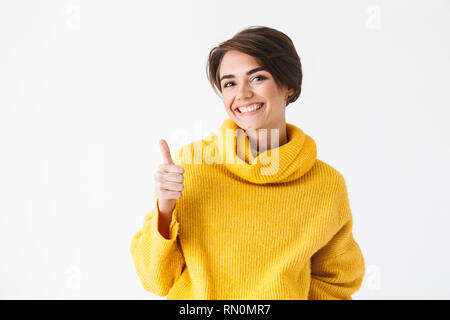 Happy cheerful girl wearing hoodie standing isolated over white background, thumbs up Stock Photo