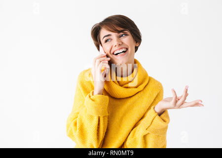 Happy cheerful girl wearing hoodie standing isolated over white background Stock Photo