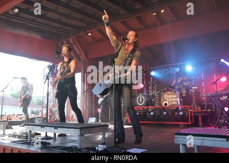 Musicians Brian Kelley and Tyler Hubbard are shown performing on stage during a 'live' appearance with Florida Georgia Line. Stock Photo