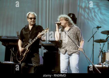 Foreigner guitarist Mick Jones and singer Lou Gramm are shown performing together on stage at the Atlantic Records Anniversary concert held at Madison Square Garden. Stock Photo