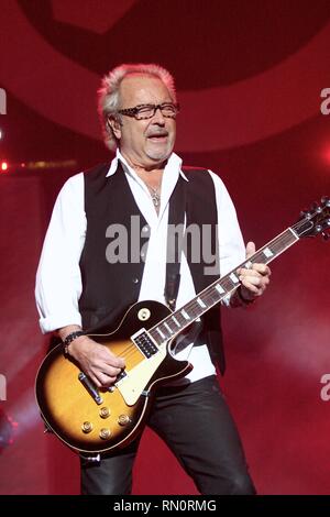 Foreigner guitarist and founding member Mick Jones  is shown performing on stage during a 'live' concert appearance. Stock Photo