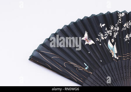 open dark blue floral theme decorated handheld folding fan Stock Photo