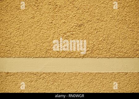 Concrete orange painted rugged, plastered wall Stock Photo