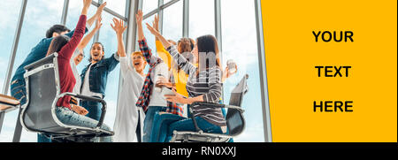Multiethnic diverse group of happy office coworker or business partner join hands celebrating together. Banner copy space for advertising text Stock Photo