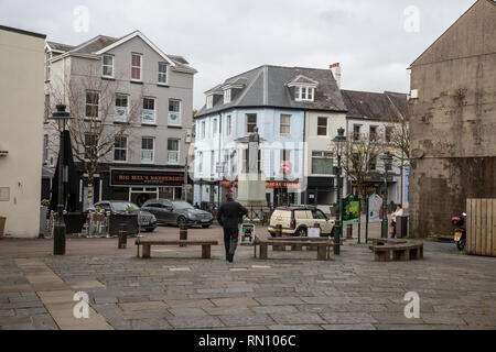 Typical view of Carmarthen Notts Square on a weekday.  Grey overcast weather and not many shoppers. Empty shops to let and parked cars. Stock Photo