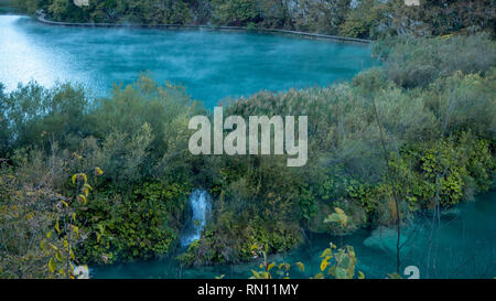 Misty Lakes at dawn within the colorful Plitvice National Park in Croatia Stock Photo