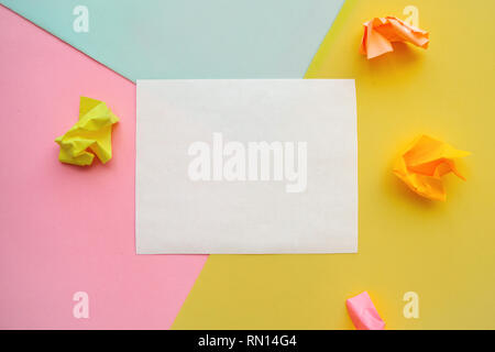 White sheet of paper for text on a colored background. Next is crumpled paper. Stock Photo