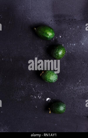 Top view of four green fruit feijoa on black background, closeup Stock Photo