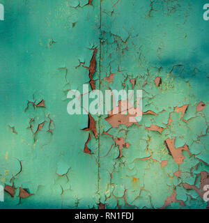 Multicolored Abstract background: Old rusty metalplate texture surface heavily aged and corroded with green paint flaking and cracking Stock Photo