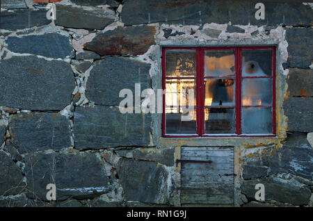 Frost on old cowshed window. Winter sun is shining through the windows Stock Photo