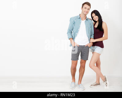 Young couple in love over isolated background very happy and excited hug each other, smiling and screaming for success. Celebration concept. Stock Photo