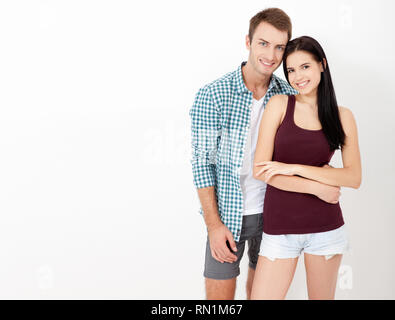 Young couple in love over isolated background very happy and excited hug each other, smiling and screaming for success. Celebration concept. Stock Photo