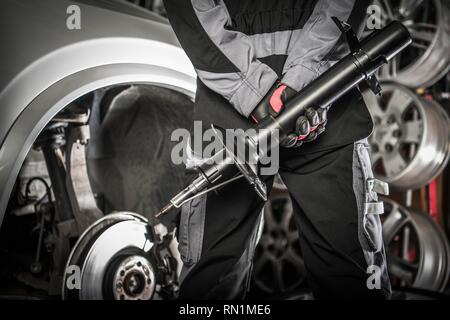Automotive Concept Car Mechanic With Shock Absorber Hydraulic Device In Hands Preparing For Necessary Absorbers Change Stock Photo Alamy