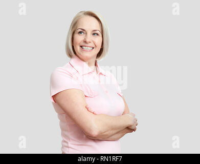 Friendly smiling middle aged woman isolated on white background Stock Photo