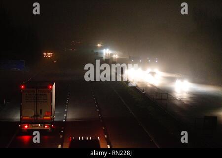 Ashford, Kent, UK. 16 Feb, 2019. UK Weather: Thick fog shrouds the town of Ashford in Kent. Traffic on the M25 motorway heading southbound towards Dover. © Paul Lawrenson 2019, Photo Credit: Paul Lawrenson / Alamy Live News Stock Photo