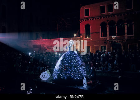 Venice, Italy. 16th Feb 2019. Crowd of people celebrating the opening of the Venice Carnival. Dancer with a lighted costume in the water parade. Credit: Gentian Polovina/Alamy Live News Stock Photo