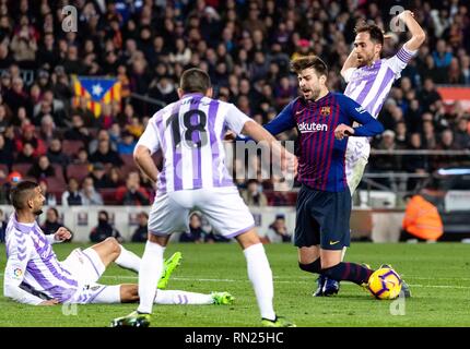 Barcelona, Spain. 16th Feb, 2019. Barcelona's Gerard Pique (2nd R) is fouled by Valladolid's Michel Herrero (1st R) in penalty area during a Spanish league match between FC Barcelona and Valladolid in Barcelona, Spain, on Feb. 16, 2019. FC Barcelona won 1-0. Credit: Joan Gosa/Xinhua/Alamy Live News Stock Photo