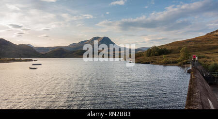 Row boats are moored in a reservoir under Baosbheinn mountain near Gairloch in the remote Northwest Highlands of Scotland. Stock Photo