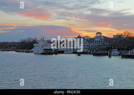 Boats, city skyline and waterfront of Alexandria, Virginia viewed from the water at sunset Stock Photo