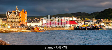 Oban, Scotland, UK - June 3, 2011: Sun shines on fishing boats and a wreck in the harbour at Oban in the West Highlands of Scotland. Stock Photo