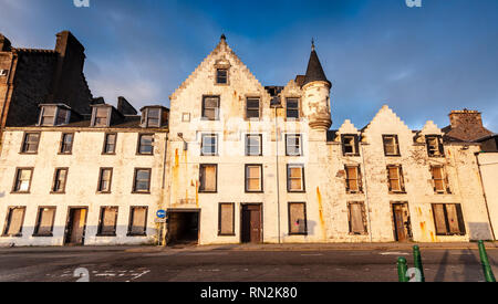 Oban, Scotland, UK  - June 3, 2011: The old Argyll Hotel stands abandoned and boarded up on the Corran Esplanade in Oban prior to its demolition. Stock Photo