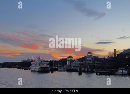 Boats, city skyline and waterfront of Alexandria, Virginia viewed from the water at sunset Stock Photo