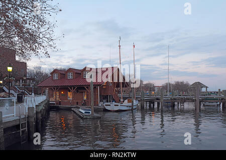 Boats and waterfront of Alexandria, Virginia viewed from the water at sunset Stock Photo