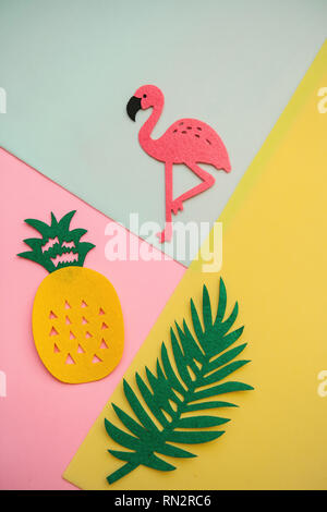 Flamingo, tropical leaf and pineapple on a colored background. Summer background. Stock Photo