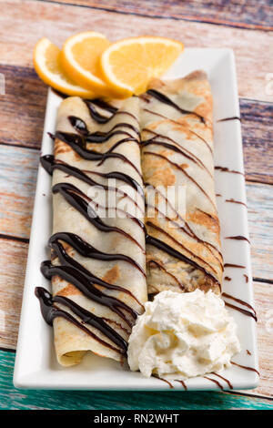 european pancakes, sweet crepe with topping on white long plate Stock Photo