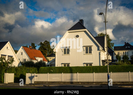 Beautiful residential houses with white picket fence in the wealthy suburb of Bygdoy peninsula, Oslo, Norway Stock Photo