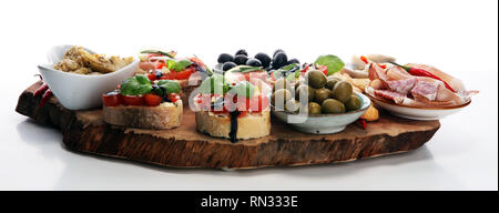 Italian antipasti wine snacks set. Cheese variety, Mediterranean olives, pickles, Prosciutto di Parma, tomatoes, artichokes on table Stock Photo