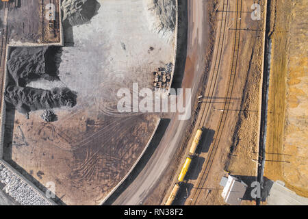 Aerial view of sandpit and factory plant producing sand materials for construction industry. Top view of industrial place. Photo captured with drone. Stock Photo
