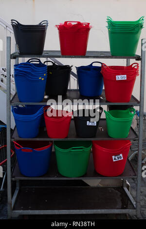 Multicoloured buckets on a shelving unit, colours include blue, red and green Stock Photo