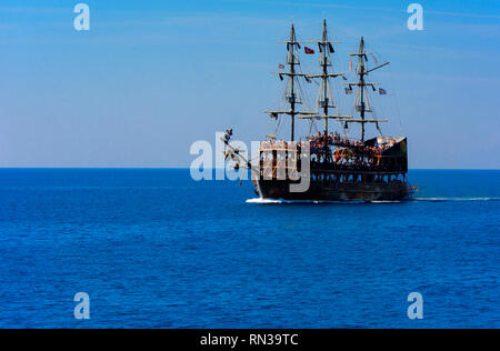 Alanya, Turkey - October 05, 2018. A large sailing ship in a pirate style in the open sea against a blue sky. Photos of the ship from the sea. The con Stock Photo