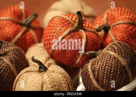 Pile of knit miniature pumpkins on orange background Stock Photo