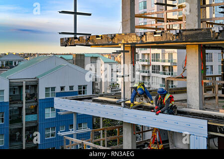 Building construction workers, Vancouver House,  Bjarke Ingels Group architects, Vancouver, British Columbia, Canada. Stock Photo